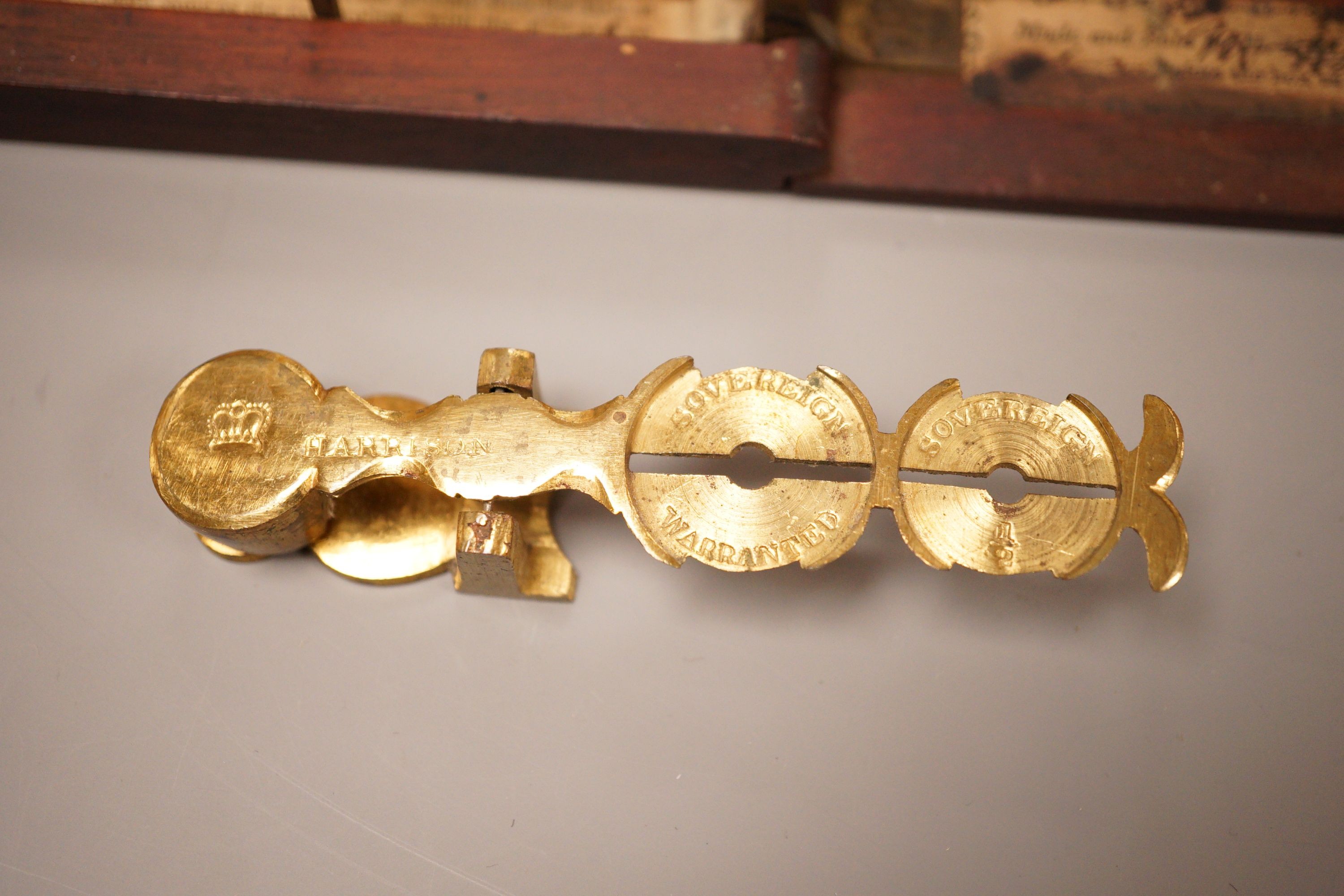 Two sets of gold / coin scales, together with a 1/2 pistol and 1 Guinea